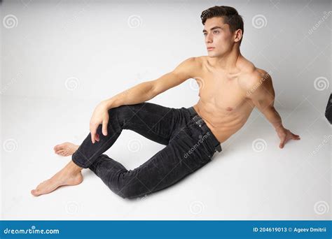Man Sitting On The Floor Naked Torso Casual Wear Background Stock Image