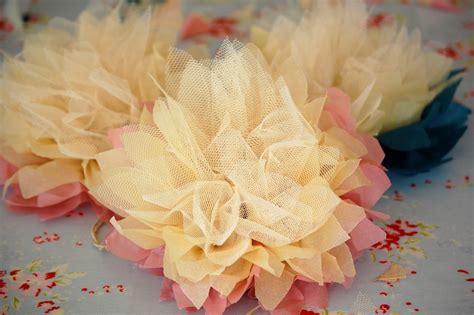 All you need to do is drape fairy lights over a curtain rod and then cover with tulle. Greedy For Colour: Tissue Paper and Tulle Flower Tutorial.