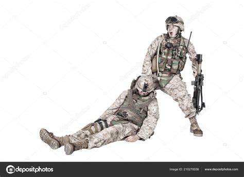 Wounded Commando Evacuating Fellow Soldier From Battlefield Stock Photo