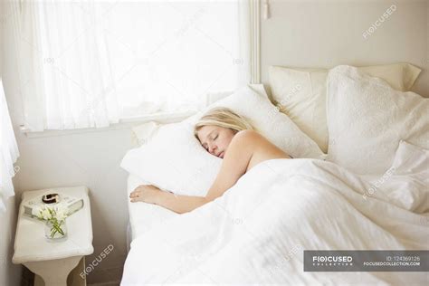 Woman Sleeping In A Bed Weekend Lie In Solitude Stock Photo