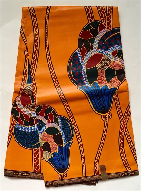 Two Pieces Of Cloth With Designs On Them Sitting Next To Each Other