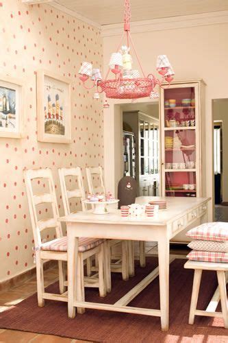 A Dining Room Table And Chairs With Pink Polka Dot Wallpaper On The