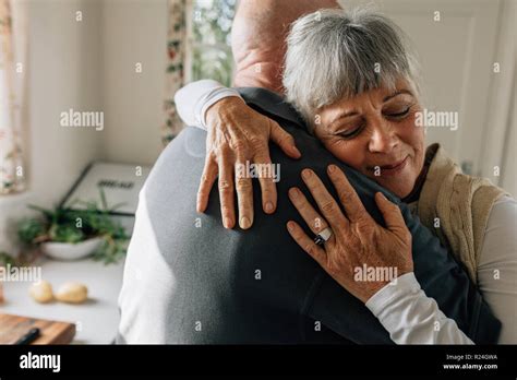 Close Up Of A Senior Woman Embracing Her Husband With Closed Eyes