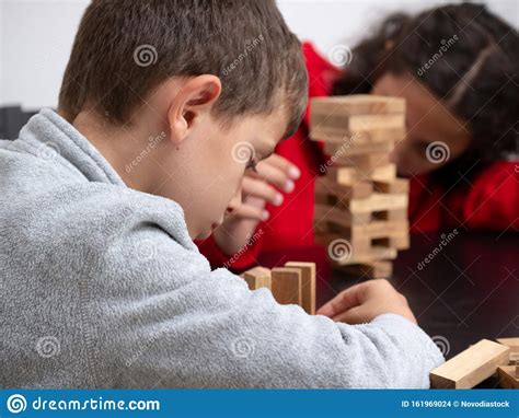 Two Children Playing Jenga At Home Stock Photo Image Of Children