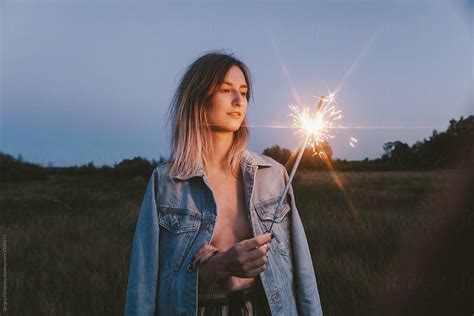 Blonde Woman With Sparkler In Field By Sergey Filimonov Stocksy United