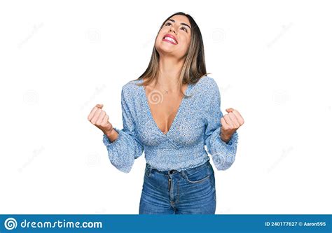 Young Hispanic Woman Wearing Casual Clothes Very Happy And Excited Doing Winner Gesture With
