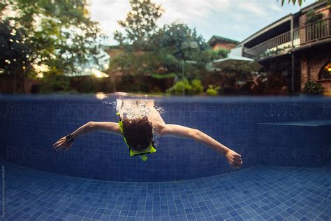 Diving Underwater In A Swimming Pool By Stocksy Contributor Angela