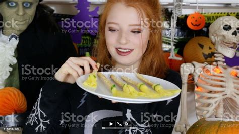 Image Of Halloween Themed Party Food Ideas Redhead Teenage Girl Holding A Plate Of Breadstick