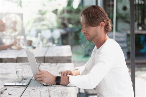Young Male Freelancer Sitting In Cafe Working In Laptop Stock Image