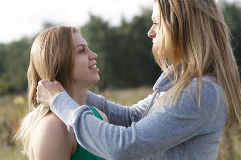 Premium Photo Lesbians Standing Face To Face On Field