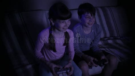 Brother And Sister Play A Computer Game With Joysticks Stock Video
