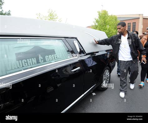 An Unidentified Man Touches The Hearse Carrying The Body Of Freddie