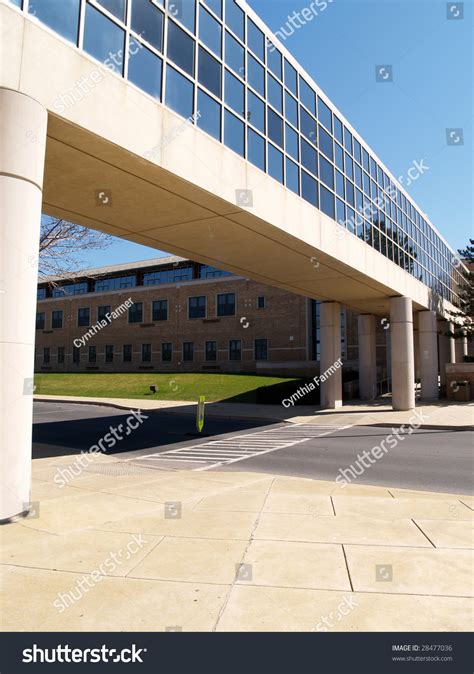 Overhead Enclosed Walkway And Sidewalk Between Two Buildings Stock