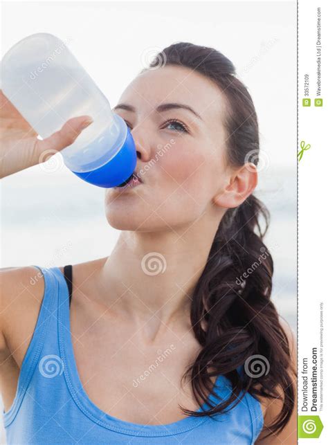 Close Up View Of Woman Drinking Water After Working Out Stock Image