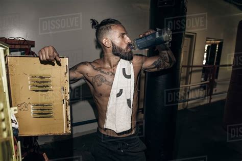 Male Boxer Drinking Water In Gym Locker Room Stock Photo Dissolve