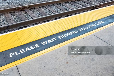 Train Platform With Sign Please Wait Behind The Yellow Line And Yellow