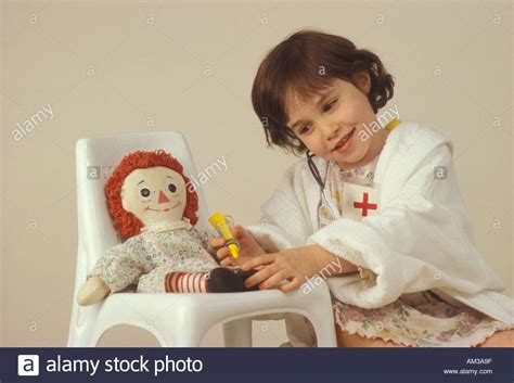 Young Girl Playing Doctor With Her Doll Stock Photo Alamy