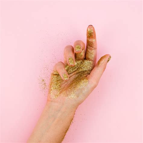 Close Up Hand With Golden Glitter Photo Free Download