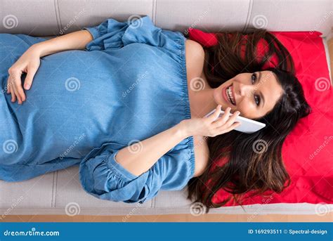 Top View Photo Of A Pregnant Woman Lying On A Sofa And Talking O Stock Image Image Of Awaiting