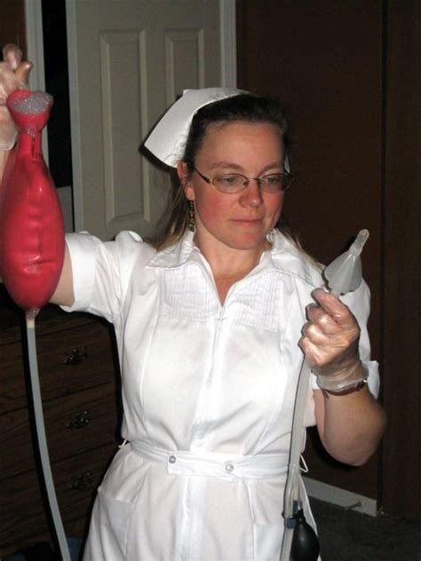 A Woman Dressed In White Holding A Blow Dryer