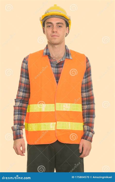 Studio Shot Of Young Man Construction Worker Standing Stock Photo