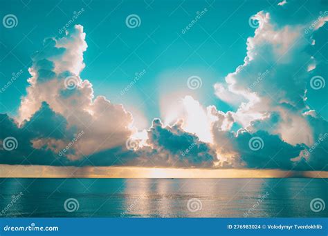 Sea Sunset With Cloudy Sky And Sun Through The Clouds Over Clouds