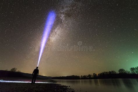 Back View Of Man With Head Flashlight Standing On River Bank Long Blue
