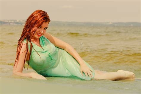 redhead woman posing in water during summertime stock image image of cheerful sensual 99024101