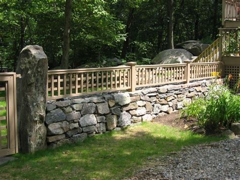 Fence On Top Of Rock Wall Stone Walls Garden Rock Wall Landscape