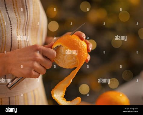 Closeup On Young Housewife Removing Orange Peel Stock Photo Alamy