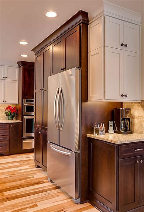 A Kitchen With White Cabinets And Stainless Steel Refrigerator Freezer