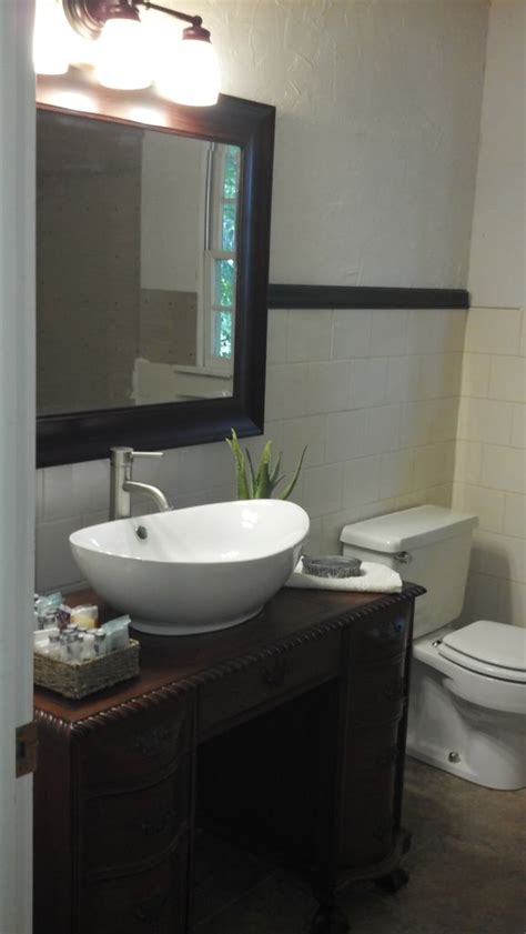 The white vessel sink contrasts well with the dark stone, helping to tie the look together. Small Bathroom Vanities With Vessel Sinks to Create Cool ...