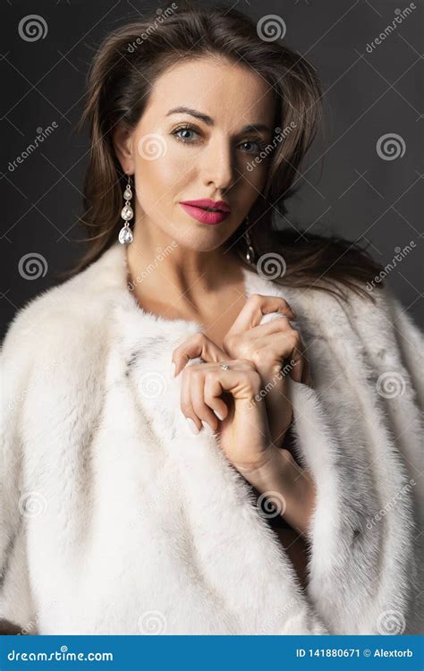 Close Up Portrait Of A Elegant Beautiful Brunette Woman Dressed In A Fur Coat Thrown Over Her