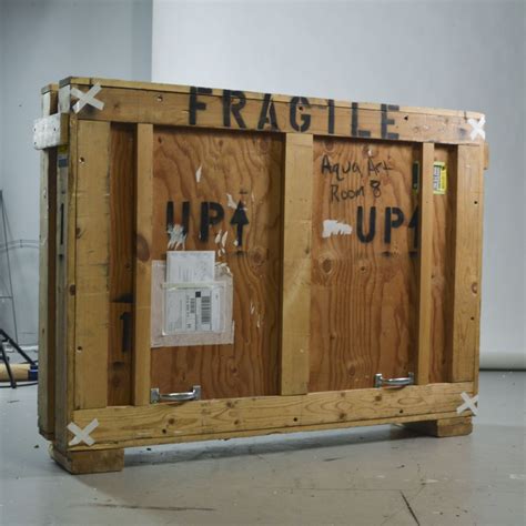 Two Wooden Crates With Graffiti On Them In A Room