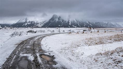 Typical Icelandic Snowy Nature Mountain Landscape And Empty Road