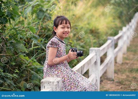 Asian Little Child Girl Holding Film Camera And Taking Photo With Of