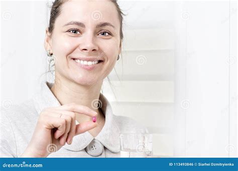 Young Attractive Woman Holds In Her Hand Pill And Glass Of Clean Stock