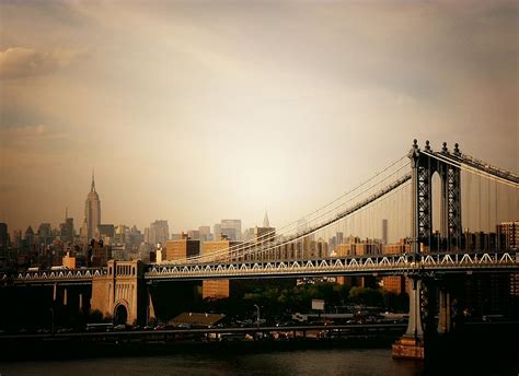 The New York City Skyline And Manhattan Bridge At Sunset Photograph By