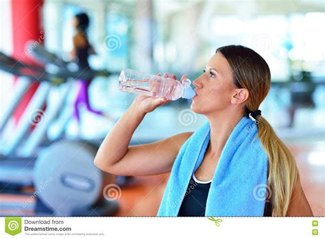 Fitness Woman Beautiful Young Girl In The Gym Drinking Water With