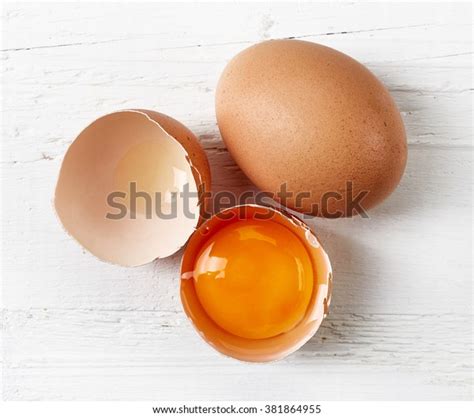 Broken Eggs On White Wooden Table Stock Photo 381864955 Shutterstock
