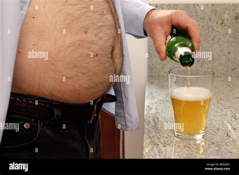 Middle Aged Man With Beer Belly Pouring A Drink Stock Photo Alamy