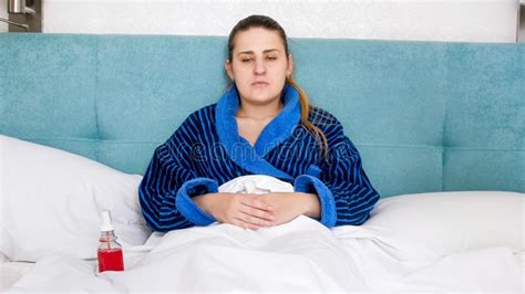 Portrait Of Young Sick Woman With High Temperature Got Flu Ling In Bed