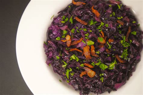 Cabbage, bacon, water, butter, salt and optionally cumin. Braised red cabbage with bacon | white plate blank slate