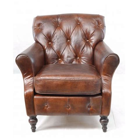 A Brown Leather Chair Sitting On Top Of A White Floor