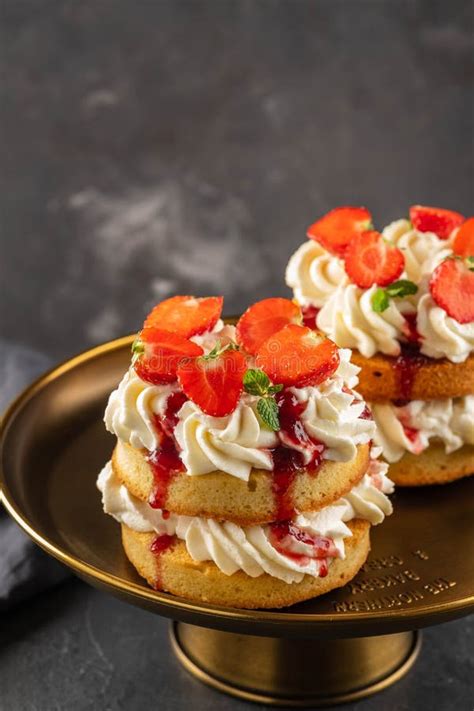 Victoria Sponge Cake With Strawberries Jam And Whipped Cream On Dark