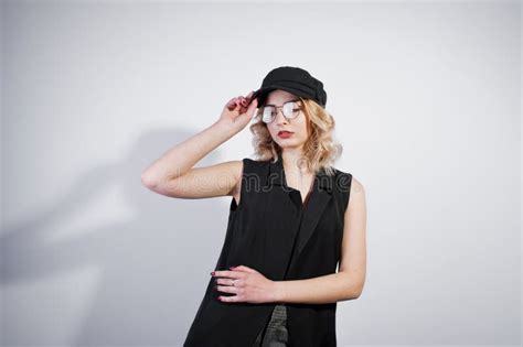 Studio Portrait Of Blonde Girl In Black Wear And Cap Stock Image