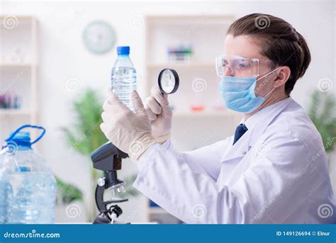 The The Young Male Chemist Experimenting In Lab Stock Photo Image Of