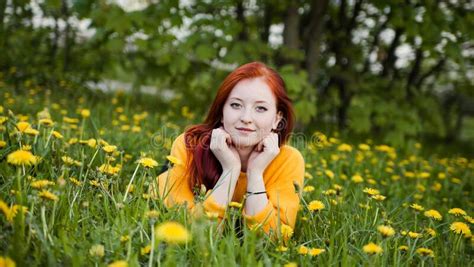 beautiful red haired girl in spring dandelions stock image image of girl green 181266501