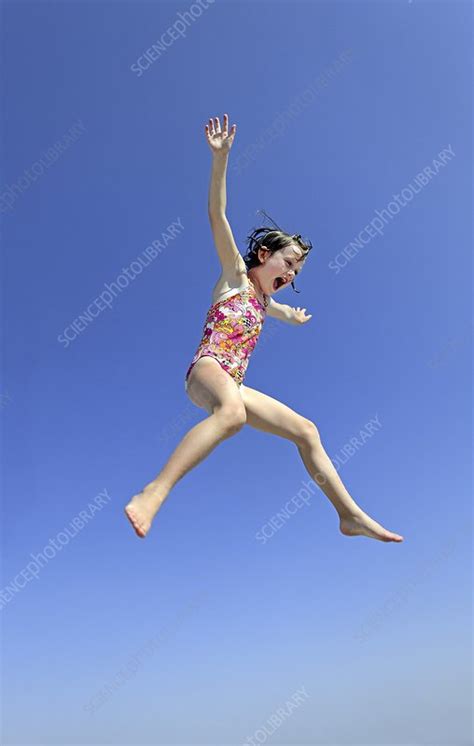 Girl Jumping Into Water Stock Image C Science Photo Library