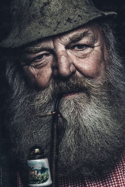Portrait Of An Old Full Bearded Man With Millinery Smoking A Pipe By